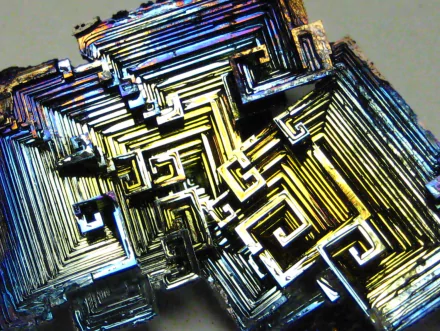 Close-up HD desktop wallpaper of a colorful bismuth crystal with intricate, geometric natural mineral formations.