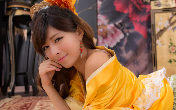 A smiling Taiwanese woman with earrings and visible tattoo, dressed in a vibrant yellow hair-dress and gown, captured in a detailed 4K Ultra HD wallpaper.