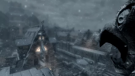 HD PC desktop wallpaper from the video game The Elder Scrolls V: Skyrim, featuring a snowy village scene with medieval-style buildings and a dragon statue.