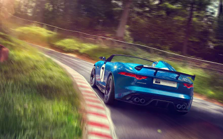 HD wallpaper of a blue Jaguar Project 7 car speeding on a winding forest road, showcasing its sleek design and dynamic performance.