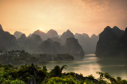 A stunning sunset over the Li River, framed by the majestic Nanling Mountains in Guangxi Zhuang, China. A breathtaking landscape showcasing nature's beauty.