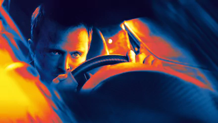 Aaron Paul intensely grips the steering wheel in this dynamic HD wallpaper from the movie Need For Speed, capturing the thrill of high-speed action.