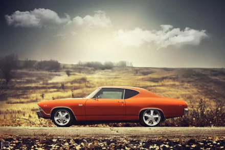 An orange Chevrolet Chevelle SS muscle car parked on a scenic road, set against a dramatic sky, showcasing its classic design and bold character.