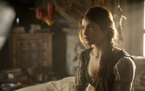 Gemma Arterton as Gretel in a scene from Hansel & Gretel: Witch Hunters, captured in a mesmerizing HD wallpaper with warm lighting and rich details.