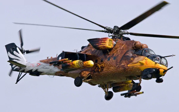 A Mil Mi-24 military helicopter with detailed fiery artwork on its body, captured in flight. 4K Ultra HD PC desktop wallpaper and background.