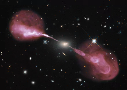A stunning Hubble image of a radio galaxy, featuring vibrant pink jets emanating from a central black hole, set against a backdrop of distant stars and galaxies.