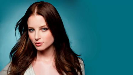 Portrait of American actress Rachel Nichols with blue eyes and brunette hair against a teal background, rendered in 4K Ultra HD quality.