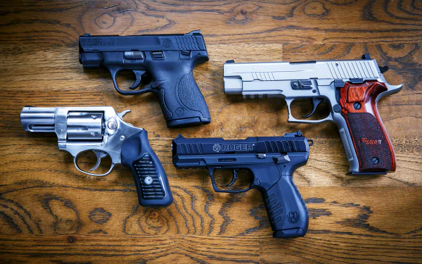 4K Ultra HD wallpaper featuring a collection of man-made pistols including Ruger, Smith & Wesson, and police-style handguns displayed on a wooden surface.