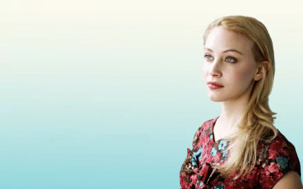 HD desktop wallpaper featuring Canadian actress Sarah Gadon with blonde hair and striking blue eyes against a soft gradient background.