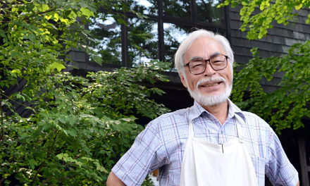 HD desktop wallpaper featuring an individual smiling outdoors, evocative of Hayao Miyazaki's spirited creativity.