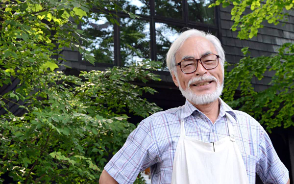 HD desktop wallpaper featuring an individual smiling outdoors, evocative of Hayao Miyazaki's spirited creativity.