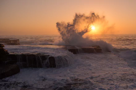 A captivating seascape at sunrise in Maroubra South, New South Wales, Australia, showcasing waves crashing against rocky shores, creating a stunning display of foam and light.