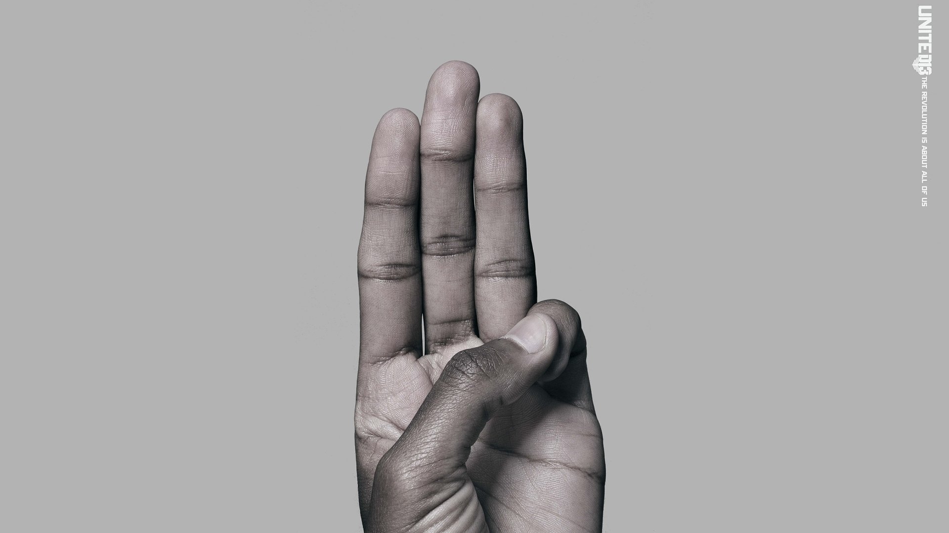Three-finger salute on a gray background from the movie The Hunger Games: Mockingjay - Part 2, 2K Quad HD PC desktop wallpaper and background.