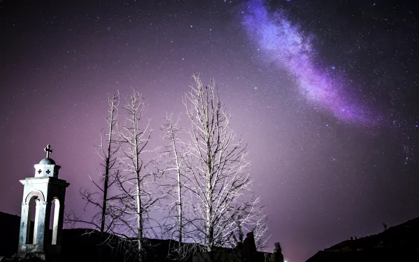 Sci‑Fi 5K Ultra HD PC desktop wallpaper/background: purple Milky Way streaks across a starry sky above bare trees and a small chapel silhouette.