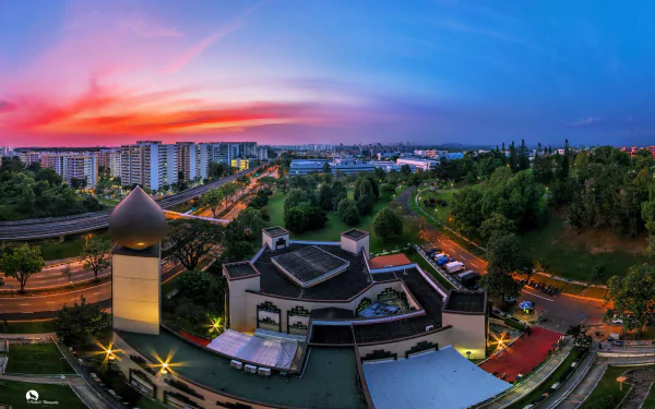 A breathtaking sunset over Singapore, featuring the Darul Makmur Mosque amidst a vibrant cityscape, capturing the essence of urban life and spirituality in stunning detail.