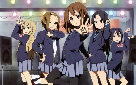 A vibrant HD wallpaper featuring characters from K-ON!, including Tsumugi, Ritsu, Azusa, Yui, and Mio, all in school uniforms with short hairstyles, performing on stage.
