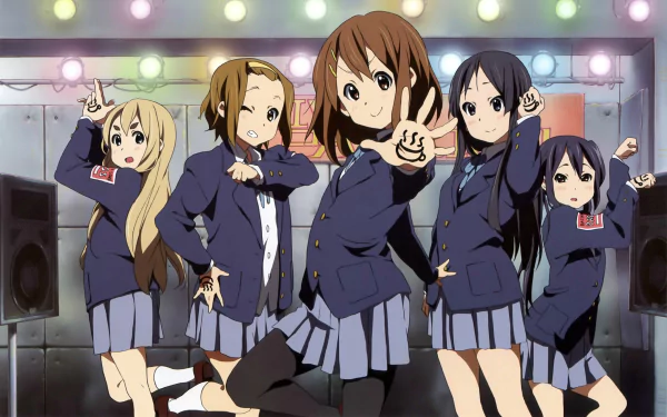A vibrant HD wallpaper featuring characters from K-ON!, including Tsumugi, Ritsu, Azusa, Yui, and Mio, all in school uniforms with short hairstyles, performing on stage.