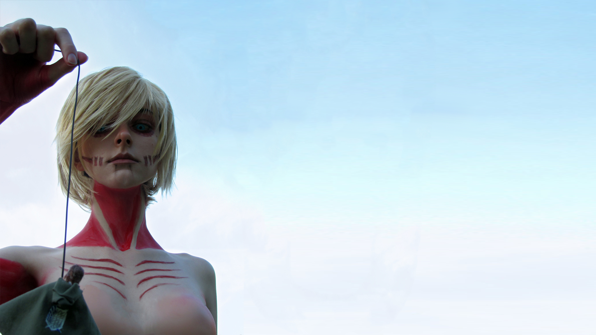 HD PC desktop wallpaper featuring a woman cosplaying as a character from Attack on Titan, showcasing detailed face and neck paint against a clear sky background.