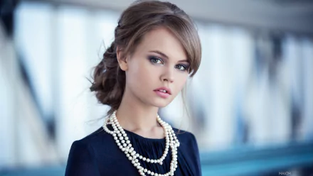 A stunning HD desktop wallpaper featuring a brunette model with green eyes and a pearl necklace against a bokeh background. The woman in the image is identified as Anastasiya Scheglova.