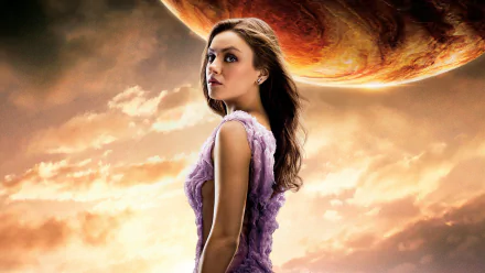 HD PC desktop wallpaper featuring Mila Kunis from the movie Jupiter Ascending, with a dramatic cosmic background and a large planet overhead.