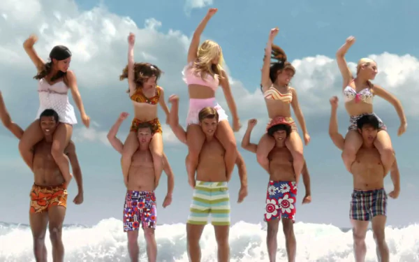 HD PC desktop wallpaper background from the movie Teen Beach Movie: five young men carry five young women on their shoulders, all in colorful beachwear, cheering on a sunny ocean shore.