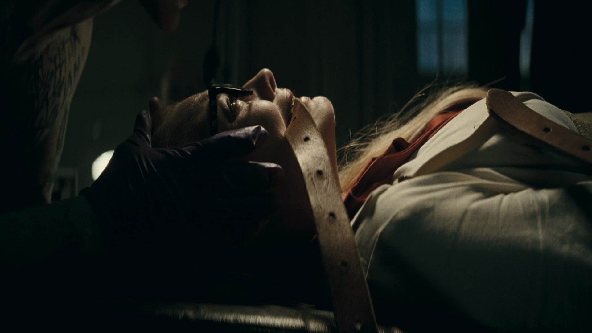 A striking HD wallpaper featuring Margot Robbie in a chilling scene from *Suicide Squad*, showcasing a dark moment that captures the film's intense atmosphere.