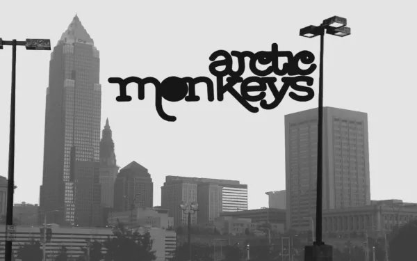 Black and white HD desktop wallpaper featuring the skyline of a city with Arctic Monkeys prominently displayed, capturing the essence of the band's urban vibe.