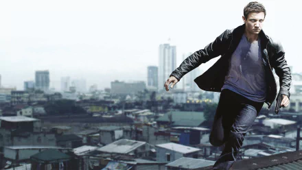 HD desktop wallpaper featuring an intense scene from the movie The Bourne Legacy with a man running on a rooftop against a cityscape background.