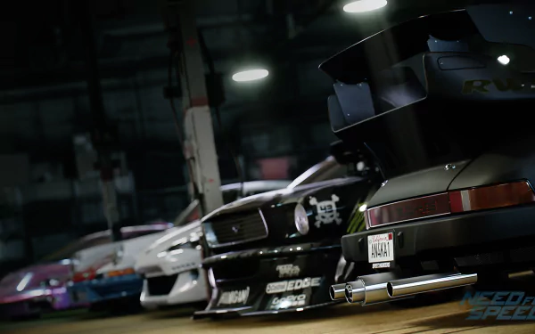 A dynamic HD wallpaper featuring sleek cars from Need For Speed (2015) showcased in a garage setting, highlighting the vibrant automotive culture of the game.