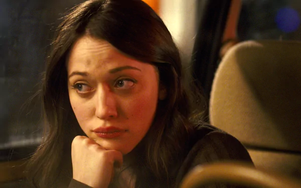 HD PC desktop wallpaper featuring celebrity Kat Dennings with a contemplative expression, seated in a car at night.
