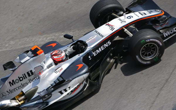 A high-performance McLaren F1 racing vehicle captured in action, showcasing its sleek design and dynamic presence in vibrant 4K Ultra HD resolution.