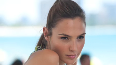 A striking HD desktop wallpaper featuring celebrity Gal Gadot, showcasing her captivating expression against a scenic background.