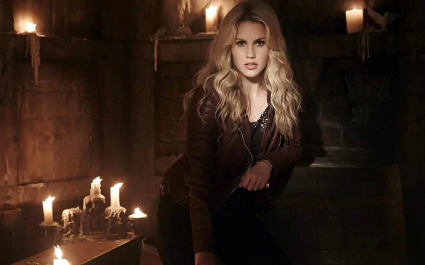 HD PC desktop wallpaper of a blonde woman in a leather jacket seated among candles on stone steps in a dim, moody chamber.