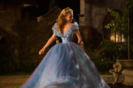 Lily James in her enchanting blue gown from Cinderella (2015), captured in a stunning 4K Ultra HD scene, showcasing her graceful silhouette in a magical setting.