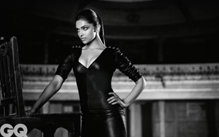 A striking black and white HD wallpaper featuring Indian actress and model Deepika Padukone, exuding confidence in a form-fitting outfit against a dramatic backdrop.
