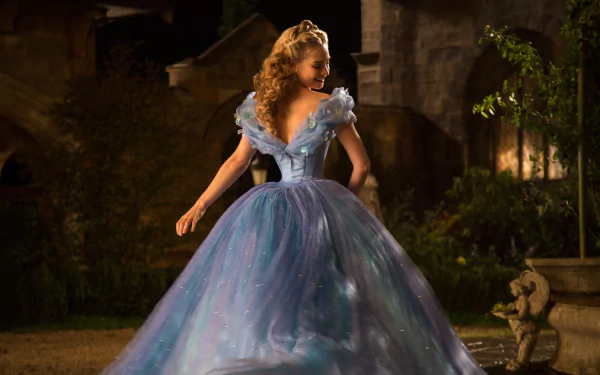 Lily James in her enchanting blue gown from Cinderella (2015), captured in a stunning 4K Ultra HD scene, showcasing her graceful silhouette in a magical setting.