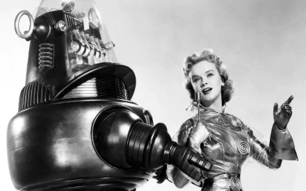 A vintage black-and-white image featuring Robby the Robot alongside Anne Francis from the movie Forbidden Planet, showcased as a striking HD desktop wallpaper.