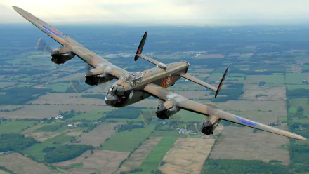 An Avro Lancaster soaring over a patchwork of green fields, captured in stunning detail. This HD desktop wallpaper showcases the iconic military aircraft in flight.