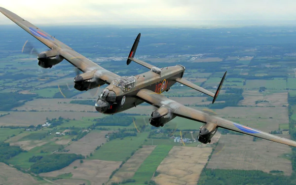 An Avro Lancaster soaring over a patchwork of green fields, captured in stunning detail. This HD desktop wallpaper showcases the iconic military aircraft in flight.