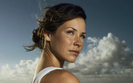 HD PC desktop wallpaper/background: close-up of a woman with windswept hair gazing toward the horizon against a dramatic cloudy sky.