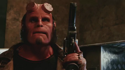 Hellboy (2004) HD desktop wallpaper featuring Ron Perlman in his iconic role, holding a large handgun and displaying his distinct red skin and sawed-off horn stubs.