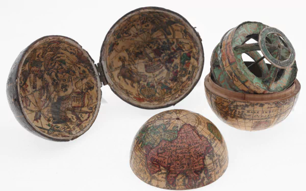 Artistic HD PC desktop wallpaper featuring an antique globe disassembled into multiple hemispheres, showcasing detailed and aged cartographic designs.