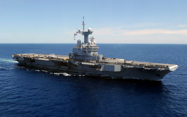 4K Ultra HD wallpaper of French aircraft carrier Charles De Gaulle (R91) underway in calm blue sea—military warship with visible flight deck.