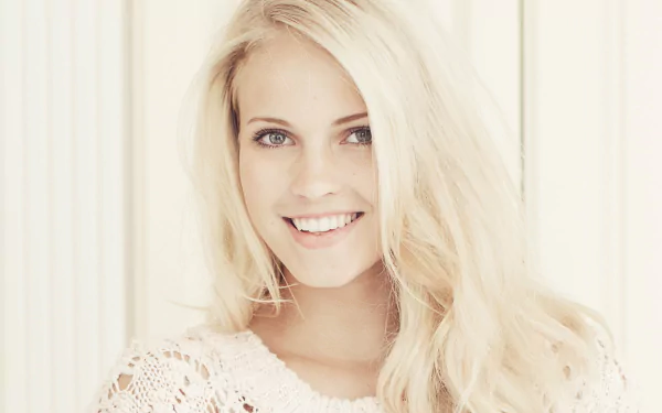 HD PC desktop wallpaper featuring a smiling woman with long blonde hair, identified as Emilie Marie Nereng, against a light, softly blurred background.