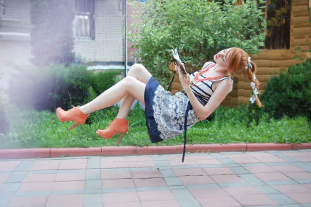 A woman with braided hair, identified as Alina Kovalenko, appears to be levitating while reading a book. She wears an outfit and vibrant shoes, set against a lush garden background. HD desktop wallpaper.