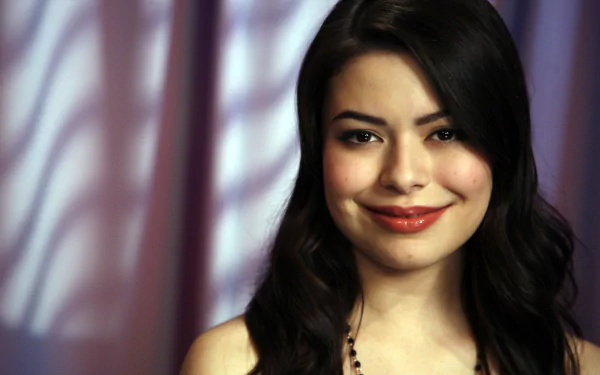 HD PC desktop wallpaper featuring a close-up of celebrity Miranda Cosgrove with a soft, blurred purple background.