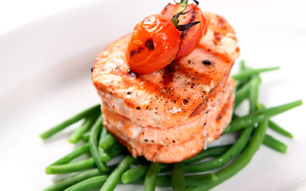 5K Ultra HD PC desktop wallpaper and background: grilled salmon medallions stacked on green beans, topped with a roasted cherry tomato on a white plate.