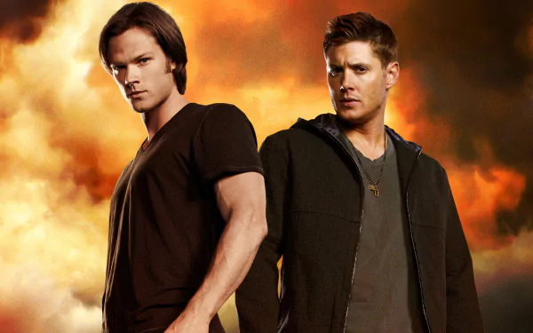 HD wallpaper featuring Jensen Ackles as Dean Winchester and Jared Padalecki as Sam Winchester from the TV show Supernatural, set against a dramatic fiery background.