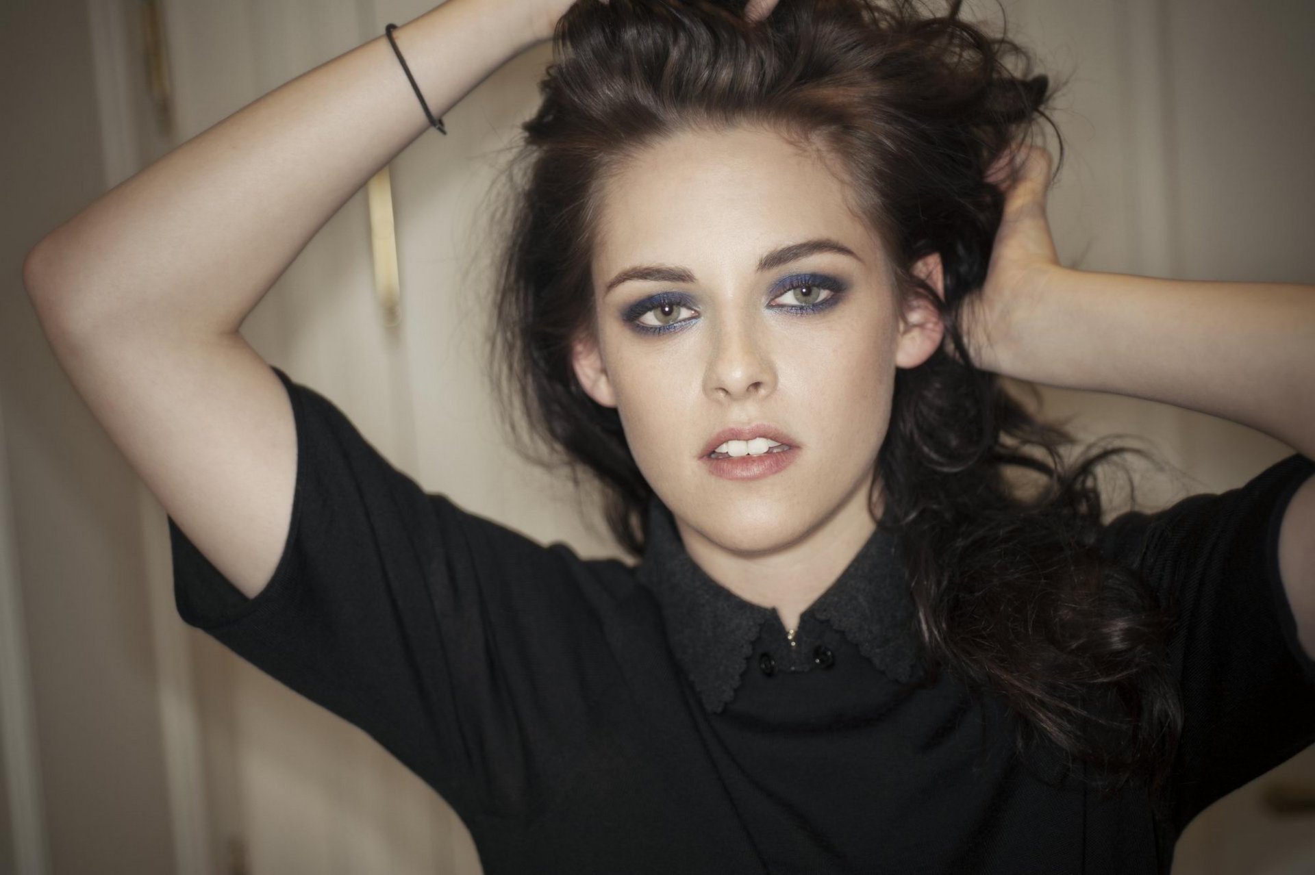 A striking HD desktop wallpaper featuring Kristen Stewart, showcasing her with tousled hair and captivating makeup against a soft background.