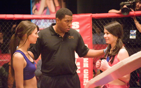 HD PC desktop wallpaper/background for TV show iCarly (2007): two young women in ring outfits face each other across a referee inside a small boxing ring.